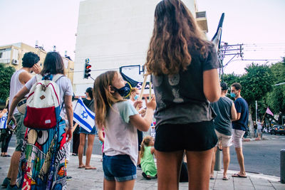 People on street against sky