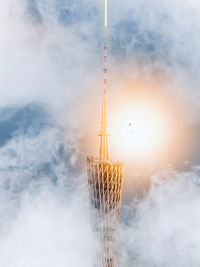 Low angle view of illuminated tower against sky