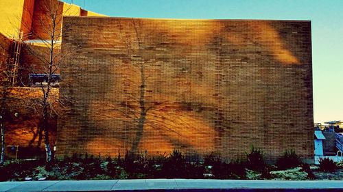 Close-up of brick wall against sky