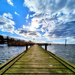 Pier over sea against sky