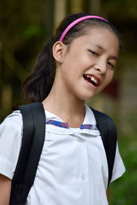 Portrait of smiling girl standing outdoors