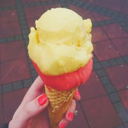 Close-up of woman holding ice cream cone