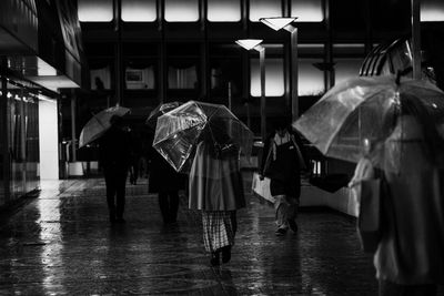 People walking in wet rain during monsoon