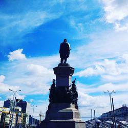 Low angle view of statue against cloudy sky