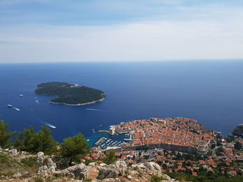 High angle view of buildings by sea against sky