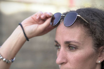 Close-up portrait of young woman wearing sunglasses