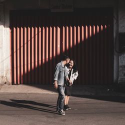 Full length of man standing against wall