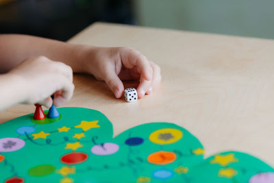 Close-up of baby playing with ball on table