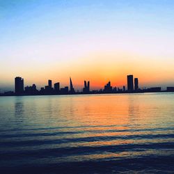 City at waterfront during sunset