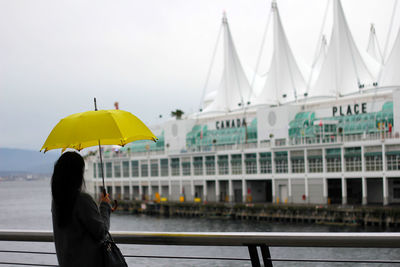 Woman holding umbrella on rainy day