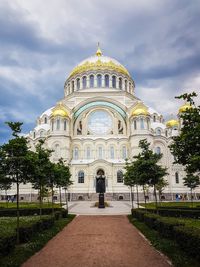 Low angle view of church against cloudy sky