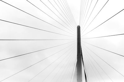 Low angle view of suspension bridge against sky