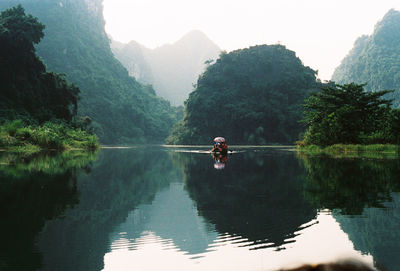 Scenic view of lake in forest against clear sky