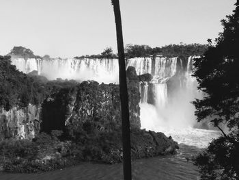 Scenic view of waterfall against sky