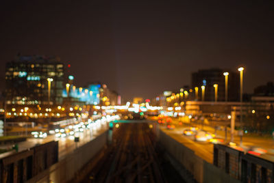 Illuminated cityscape against sky at night