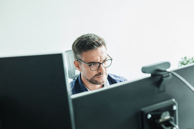 Young man using laptop at office