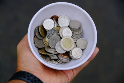 Close-up of hand holding coins