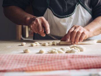 Midsection of man preparing food on table