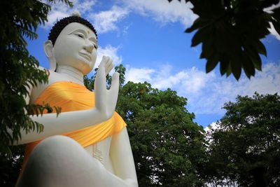 Low angle view of statue against trees