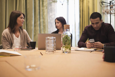 Business people sitting at conference table in board room