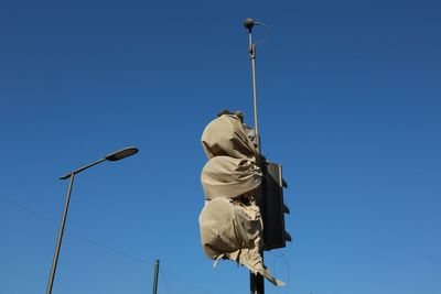 Low angle view of street light against clear blue sky