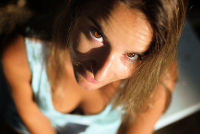 Close-up portrait of woman sitting at home