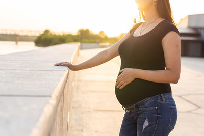 Midsection of woman standing outdoors