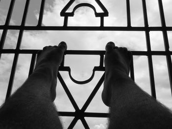 Low section of person holding window against sky