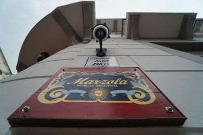 Low angle view of information sign on table