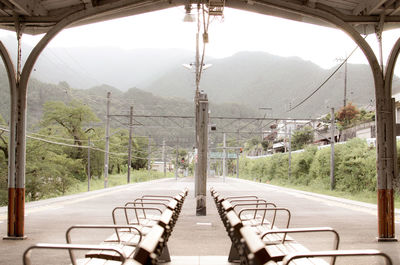 Empty road by mountains seen through window