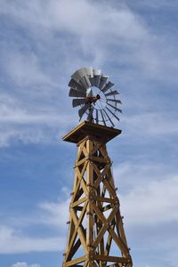 Low angle view of traditional windmill against sky