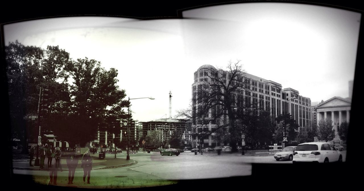 building exterior, architecture, built structure, transfer print, city, car, street, land vehicle, auto post production filter, city life, street light, city street, tree, incidental people, transportation, building, clear sky, mode of transport, sunlight, road