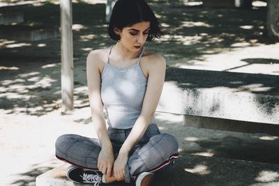 Portrait of young woman sitting outdoors