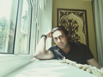 Portrait of young man sitting at home