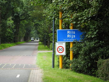 Road sign by trees