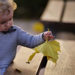 Portrait of woman holding leaf