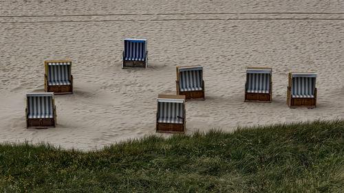 High angle view of lounge chairs at beach