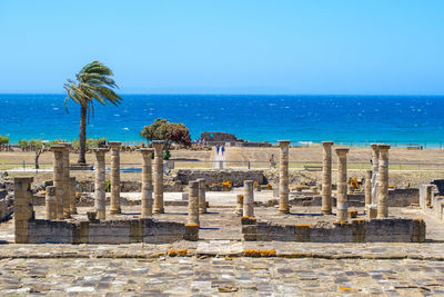 Built structure on beach against blue sky