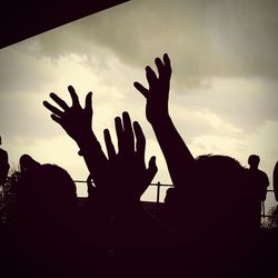 Low angle view of silhouette hand against sky during sunset