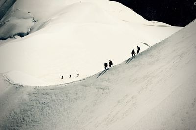 People skiing on snowcapped mountain