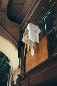 Low angle view of clothes hanging on ceiling of house