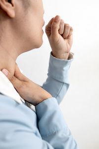Midsection of woman with hands against white background