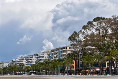 Buildings by street against sky