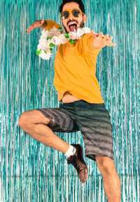 Portrait of young man jumping in swimming pool