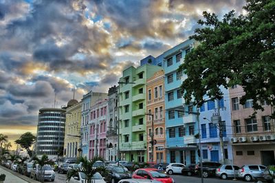 Buildings in city against cloudy sky