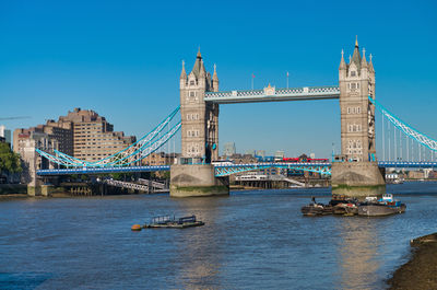 Bridge over river with city in background