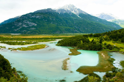 Scenic view of lake and mountains against sky