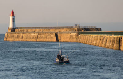 Sailor fisherman on his boat leaving the port