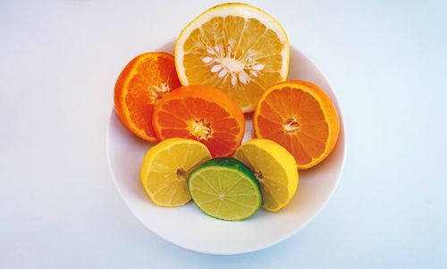 Close-up of orange fruit against white background