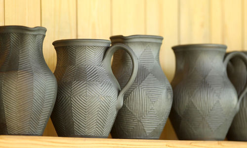 Close-up earthenware against wooden wall